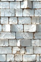 Old white brick wall with cracked paint and weathered surface texture showing distressed vintage patina and natural aging patterns. Suitable for urban design backgrounds.