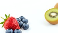 Fresh mixed berries and kiwi fruit on white background. Healthy organic food ingredients for smoothies, breakfast or snacking isolated for design use.