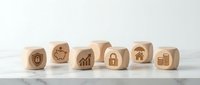 Wooden cubes with business and security icons including shield, piggy bank, growth chart, padlock, house and building symbols on white background.