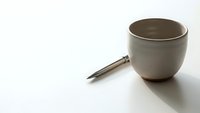 Modern ceramic coffee cup with wooden handle on white background isolated for design projects and commercial use.