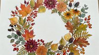 Watercolor autumn wreath with colorful fall leaves, berries, dahlias, and wildflowers arranged in a circular frame on white background.