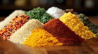 Vibrant piles of colorful ground spices and seasonings including turmeric, paprika, and curry powder arranged on wooden surface, macro food photography.