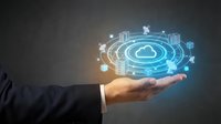 Businessman holding glowing cloud computing network hologram with connected digital icons, representing modern data storage and technology innovation.