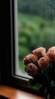 Fresh pink roses bouquet near window with natural light and green garden background for romantic home decor and floral arrangements.