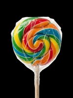 Rainbow swirl lollipop wrapped in plastic on transparent background, ready for stickers, t-shirt design, clipart, print on demand, and sublimation projects.