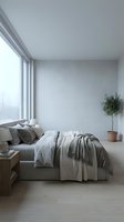 Minimalist bedroom interior with gray upholstered bed, neutral bedding, wooden nightstand, potted plant, and large window with natural light for home decor and design projects.