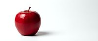 Fresh red apple isolated on white background for healthy eating and nutrition concepts.