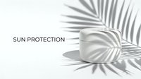 Sunscreen jar with palm leaf shadow on white background, ideal for skincare and cosmetic product marketing campaigns.