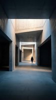Lone figure walking through modern concrete corridor with dramatic natural lighting and minimalist architectural design creating atmospheric perspective.