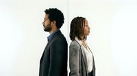 African American business couple standing back to back in professional attire against white background for corporate and relationship concepts.