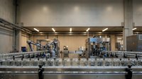 Modern industrial factory interior with automated conveyor belt system and manufacturing equipment for production and logistics operations.