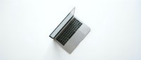 Modern silver laptop computer open on clean white background, top view perspective for business and technology presentations.