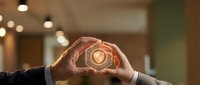Hands forming heart shape around glowing light bulb symbolizing innovation, creativity, and sustainable energy solutions for business and technology concepts.