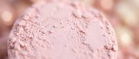 Close-up of finely milled pink powder with soft texture, suitable for cosmetics, makeup, beauty products, and skincare packaging design.