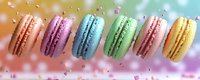 Colorful macarons in pastel rainbow colors arranged in a row with confetti and bokeh background, showcasing sweet dessert variety.