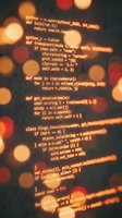 Python programming code on computer screen with warm bokeh lights background for software development and coding projects.
