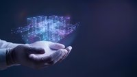 Businessman hand holding glowing digital holographic city buildings with network connections on dark background for smart city technology and urban development concepts.