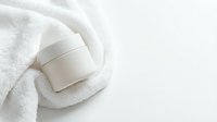 Cosmetic jar with white cream or moisturizer on soft towel, skincare and beauty product packaging for cosmetics, wellness and spa branding.
