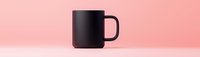 Black ceramic coffee mug on pink background for branding mockup and product presentation in minimalist style.