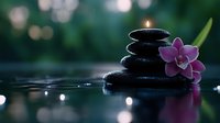 Zen spa stones with purple orchid flower and candle flame creating peaceful meditation atmosphere with water reflections and soft bokeh lighting.