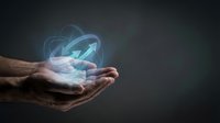 Close-up of male hands holding glowing digital globe with orbital lines, representing global connectivity, technology innovation, and worldwide business communication solutions.