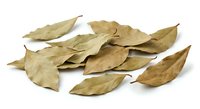 Dried bay leaves scattered on white background, aromatic culinary herbs for cooking and seasoning, natural spice ingredient isolated for design use.