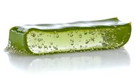 Fresh aloe vera leaf slice with water drops and gel texture on white background, natural organic skincare ingredient for cosmetics and medicine.
