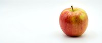 Fresh red apple with yellow undertones isolated on white background, ready for culinary, nutrition, and health-related design projects.