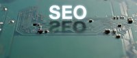 Green circuit board with glowing white SEO text overlay representing search engine optimization and digital marketing technology concepts for web development.