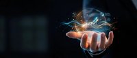 Businessman hand holding glowing digital brain with circuit connections and data streams representing artificial intelligence and machine learning technology.