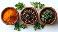 Wooden bowls with turmeric powder, black peppercorns and chopped parsley on white background. Fresh aromatic spices and herbs for cooking.