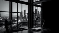 Executive office workspace with modern black leather chair, desk, and floor-to-ceiling windows overlooking urban cityscape skyline at dusk. Corporate environment for business professionals.