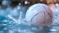 White water polo ball splashing into pool with dynamic water droplets and bokeh background, capturing sports action moment in aquatic competition.