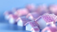 Miniature white houses in dreamy arrangement with soft pink and purple bokeh effect creating magical residential neighborhood atmosphere.