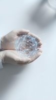 Hands protecting glowing digital network sphere with connected nodes representing data security, technology innovation and global connectivity solutions.