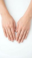 Female hands with natural manicure on white background showing healthy skin and nails for beauty skincare cosmetics advertising.