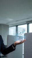 Businessman holding glowing holographic business dashboard with charts, graphs, and analytics data floating above hand in modern office.