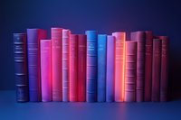 Row of vintage hardcover books in pink, blue and purple shades standing on shelf against dark background with dramatic neon lighting creating moody atmosphere.