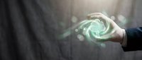 Businessman hand holding glowing green spiral energy vortex with bokeh light effects, representing innovation, technology, power, and digital transformation for business concepts.