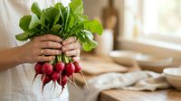Fresh red radishes with green leafy tops held in hands over rustic kitchen counter, promoting organic produce, farm-to-table cooking, and healthy eating.
