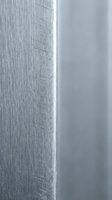 Brushed aluminum metal surface with scratched texture and smooth polished steel edge detail for industrial design and modern architecture backgrounds.