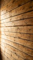 Natural wood planks wall texture with horizontal boards showing grain patterns and knots for rustic interior design and construction projects.
