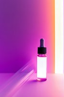 Glass dropper bottle with pink liquid against vibrant purple and orange gradient background, creating modern minimalist composition for cosmetic and wellness products.