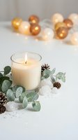 Burning candle with eucalyptus leaves and pine cones creating cozy winter atmosphere with warm bokeh lights for home decor and relaxation.