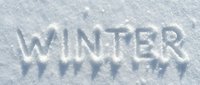 Word WINTER written in fresh white snow, natural texture background for seasonal greeting cards and holiday designs.
