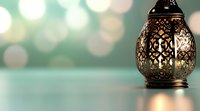 Traditional oriental lantern with ornate metalwork casting intricate shadows against soft bokeh background in mint green and gold tones. Perfect for Ramadan designs.