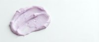 Lavender cosmetic cream or moisturizer swatch on white background for skincare, beauty product packaging, and cosmetics advertising purposes.
