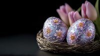 Decorative purple Easter eggs with floral pattern in natural nest with pink tulips on dark background. Elegant holiday composition with selective focus.