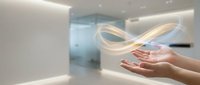 Hands presenting glowing infinity symbol in modern minimalist interior space representing endless possibilities and continuous innovation in business technology.