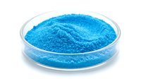 Bright turquoise powder in petri dish, fine granular texture, laboratory or cosmetic ingredient display, isolated on white background.